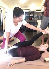 Yoga Teacher learns advanced compression stretching to improve range of motion at hip joint